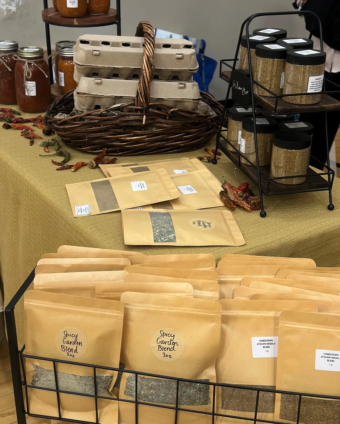 Farm market table display with fresh eggs and homemade spice blends