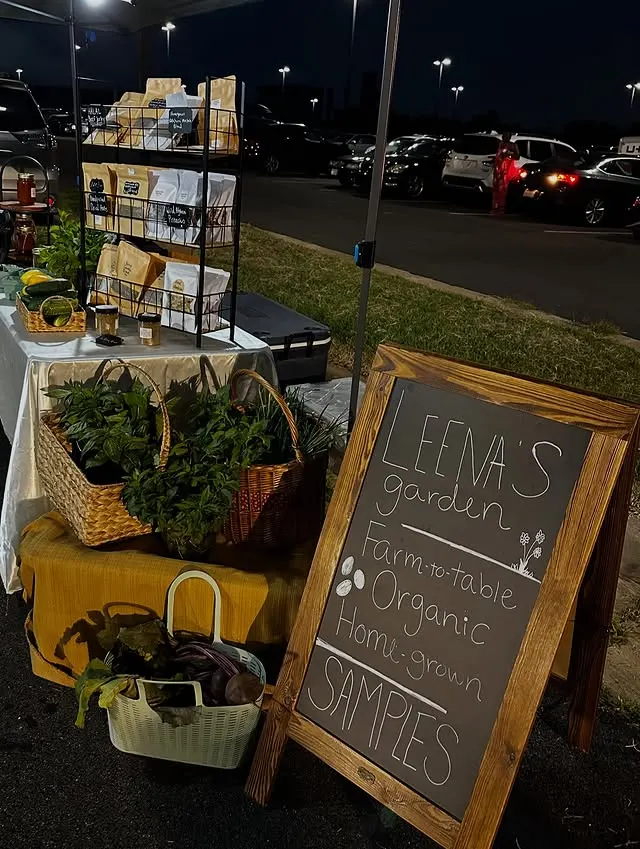 Leena’s Garden farmers market booth sign and setup